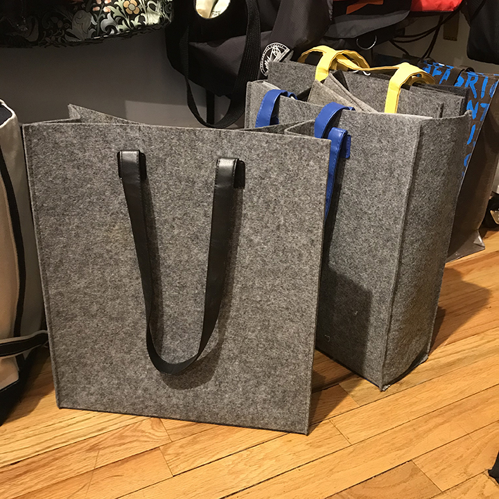custom felt tote bags in showroom