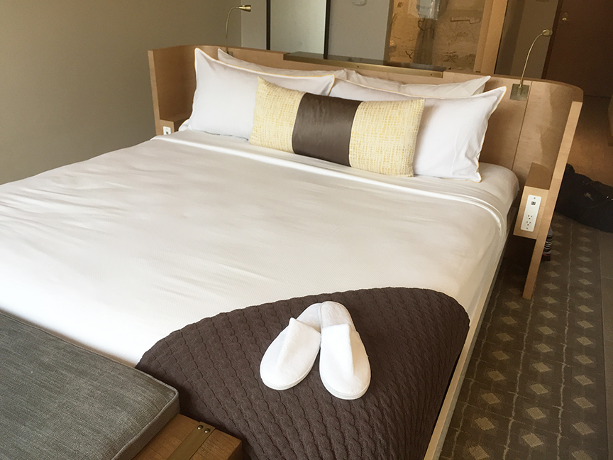 Slippers on Hotel Bed